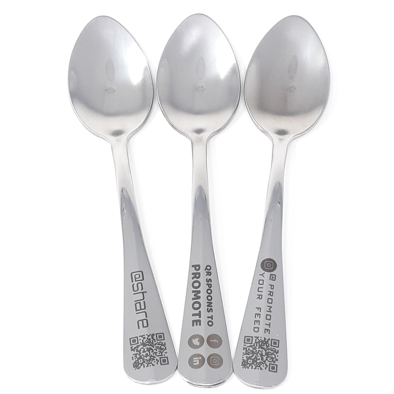 Showing teaspoons laser engraved with business details