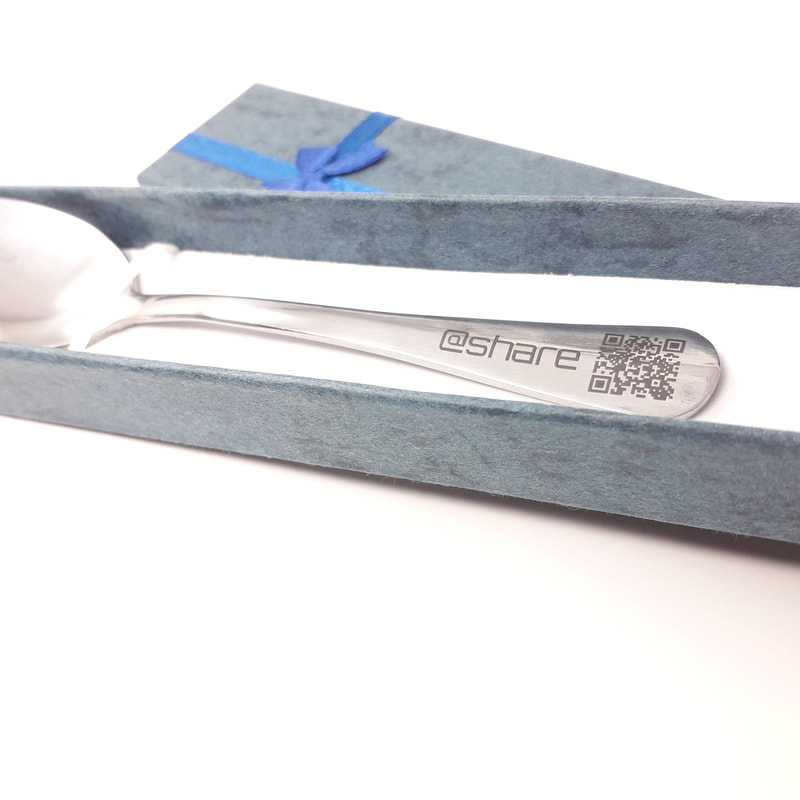 Teaspoon laser engraved with business name and social media details and a QR code