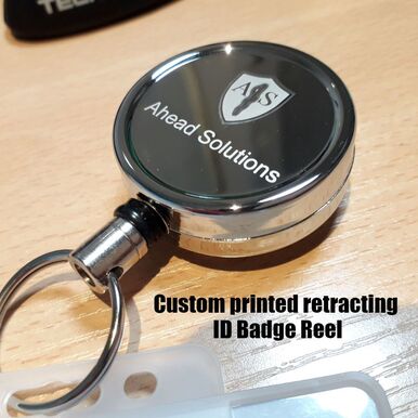 Pull out retracting ID badge holder reels engraved with custom logo and branding 